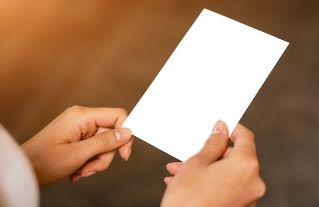 Una persona que sostiene un papel en blanco en la mano. Foto de alta calidad