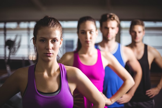 Personas en forma con las manos en las caderas en el gimnasio