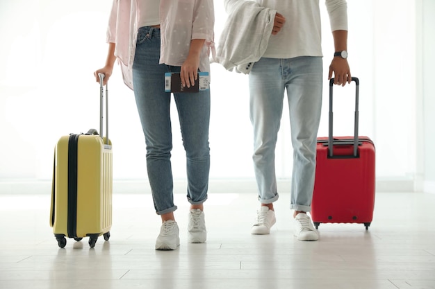 Personas con maletas de viaje brillantes en el aeropuerto.
