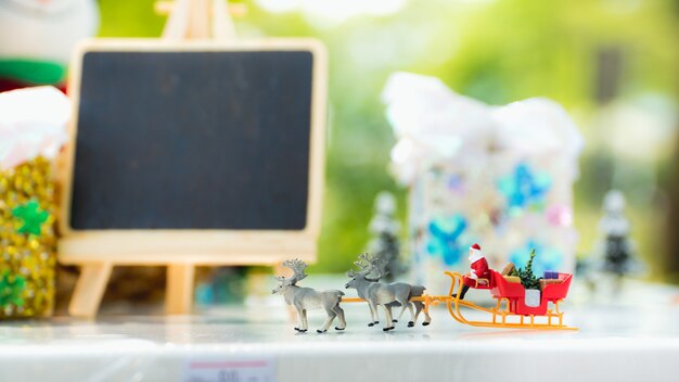 Personas miniatura, Santa Claus paseo vehículo de lluvia en decoraciones de Navidad utilizando como Navidad y