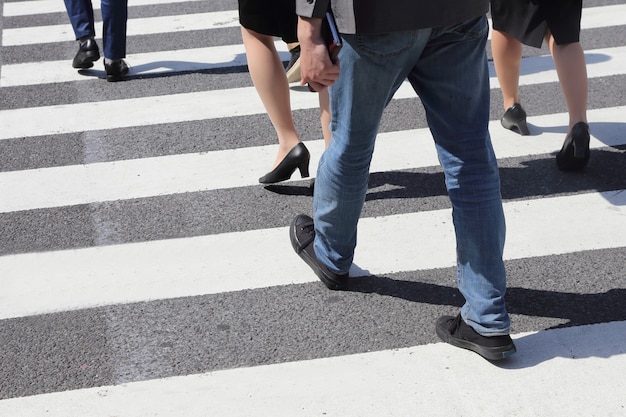 Personas no identificadas piernas cruzando calle