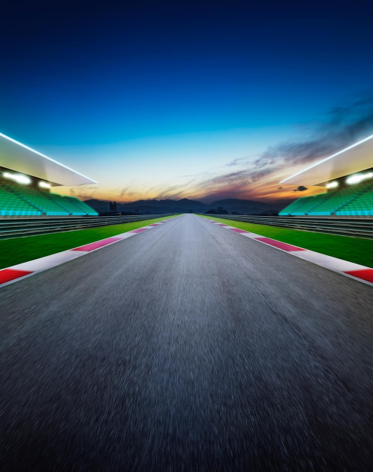 Foto perspectiva decreciente de una pista de carreras de automóviles vacía contra el cielo durante la puesta de sol
