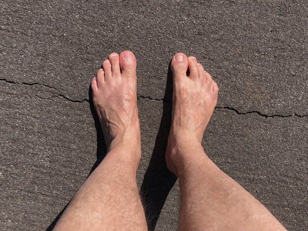 Foto pés descalços pisando na grama e chão de terra