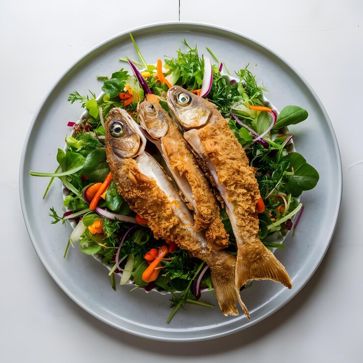 Pescado a la parrilla con rúcula y tomates cereza en un plato blanco