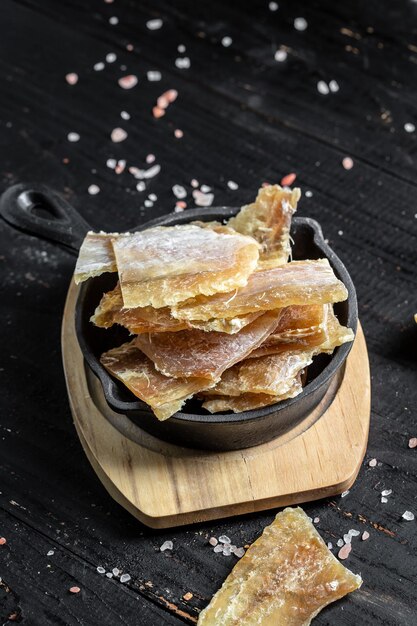 Pescado secado al sol fundidos salados sobre fondo de madera Merienda para cerveza secado fundidos banner menú receta lugar para vista superior de texto