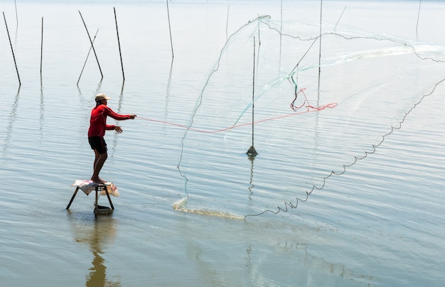 Foto pescador, jogar, rede, em, a, pântano