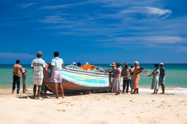 Pescadores locais puxam uma rede de pesca do oceano índico