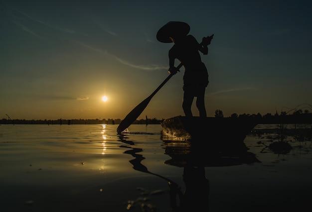 Pescadores que usam redes de pesca, pescadores que pescam na luz dourada do amanhecer.