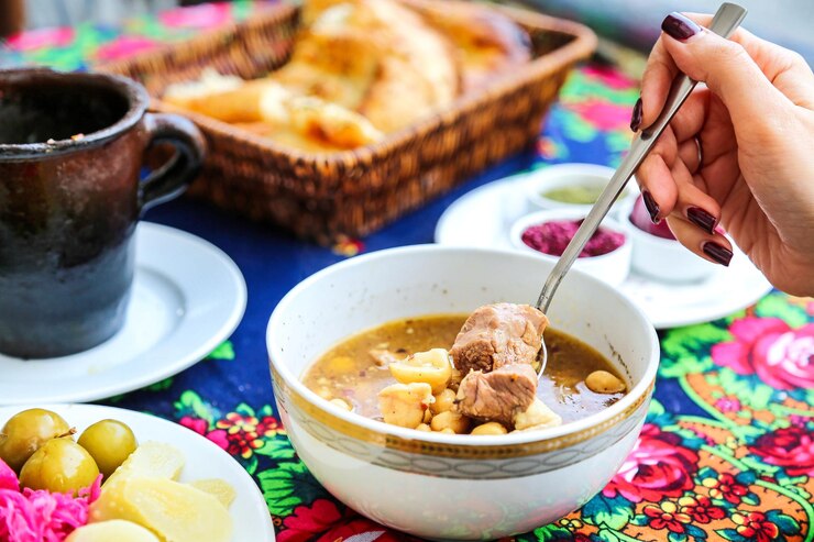 Foto pessoa comendo uma tigela de sopa com uma colher