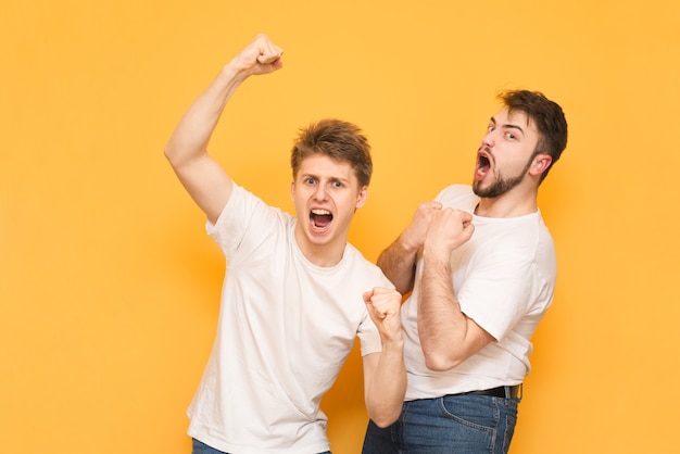 pessoas com roupas básicas sorrindo e cerrando os punhos como vencedores ou pessoas felizes isoladas no amarelo