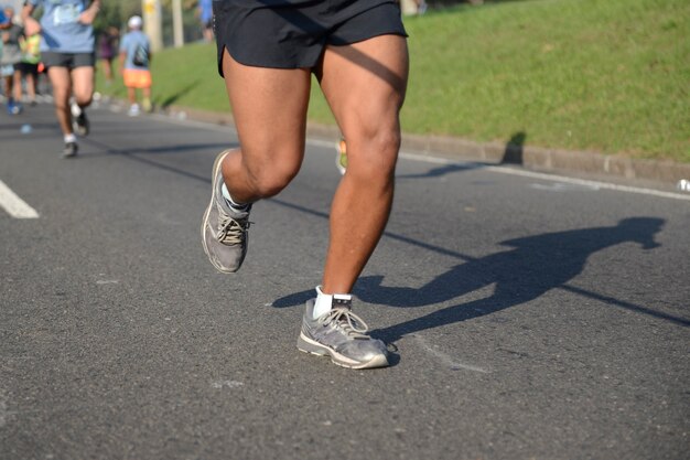 Pessoas correndo em uma corrida de rua em uma superfície de asfalto