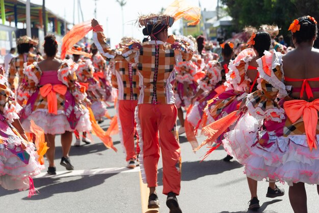 Pessoas de grupos culturais são vistas dançando durante o desfile pré-carnaval de Fuzue na cidade de Salvador Bahia