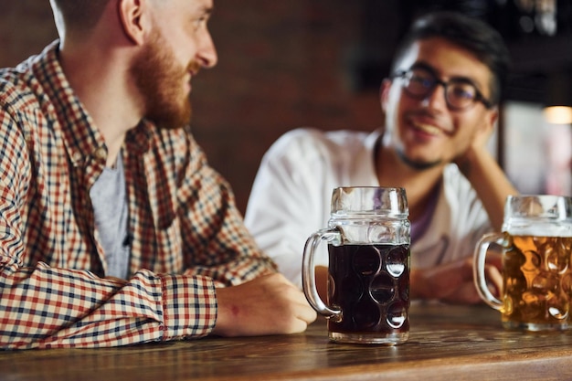 Pessoas em roupas casuais sentadas no pub e conversando