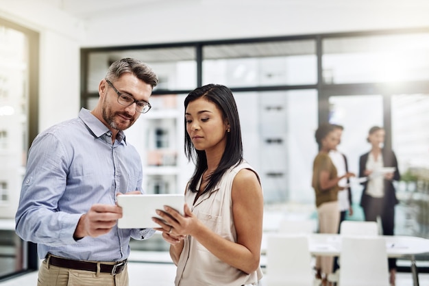Pessoas empregadas e sérias no escritório em tablet para trabalho em equipe ou colaboração e projeto Discussão de ideias e mentor para compartilhar informações na internet ou on-line para desenvolvimento de habilidades ou carreira
