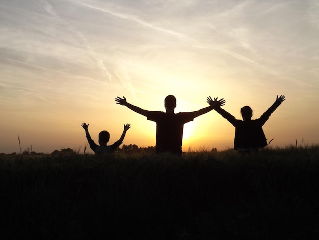 Pessoas no campo ao pôr-do-sol