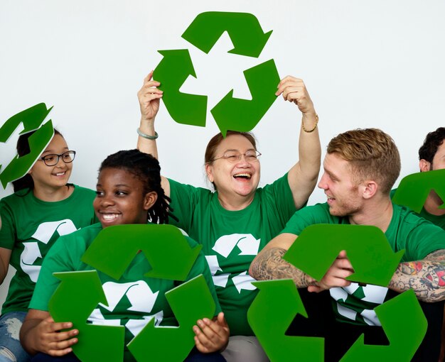 Pessoas no grupo vestindo camisas de ícone de reciclagem e posando para foto