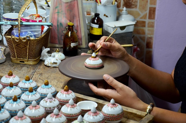 Pessoas tailandesas woking processo de pintura Ceramic Benjarong é cerâmica tradicional tailandesa estilo cinco cores básicas