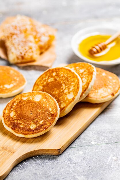 Pfannkuchen auf einem Schneidebrett mit Honig