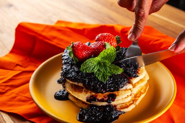 Foto pfannkuchen, gefüllt mit obst und mit roter fruchtmarmelade