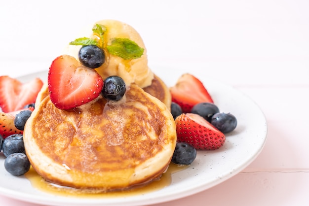 Pfannkuchen mit Heidelbeeren, Erdbeeren, Honig und Vanilleeis