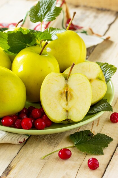 Äpfel und Preiselbeeren auf einem grünen Teller