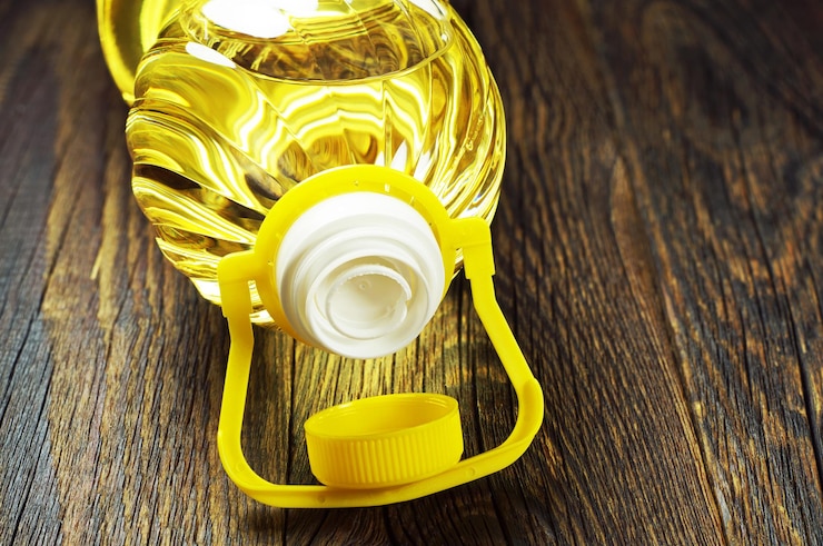 Foto pflanzenöl in plastikflasche auf altem holztisch closeup