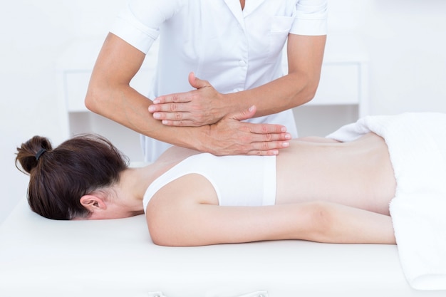 Physiotherapeut, der Rückenmassage tut