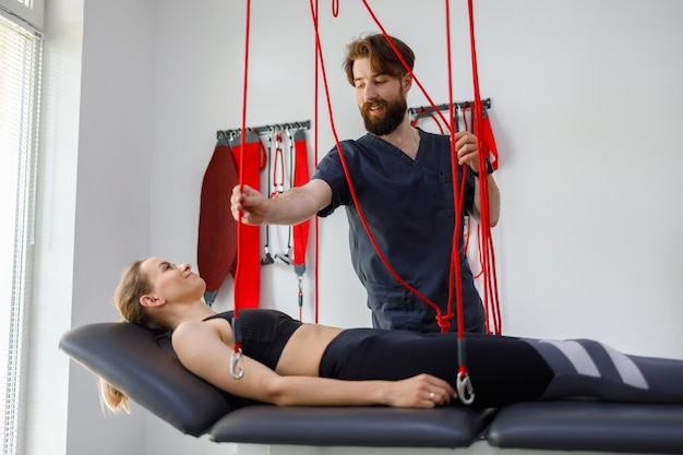 Physiotherapeut unterstützt Patientin bei rehabilitativer Physiotherapie