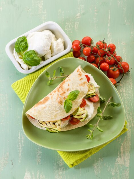 Piadina con mozzarella grelled calabacines y tomates sándwich típico italiano