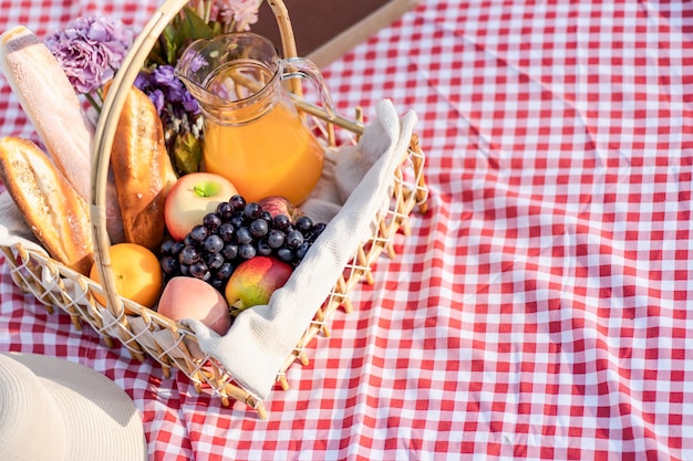 Picknick-Mittagessen-Mahlzeit im Freien Park mit Picknickkorb, der die Picknickzeit in der Parknatur im Freien genießt