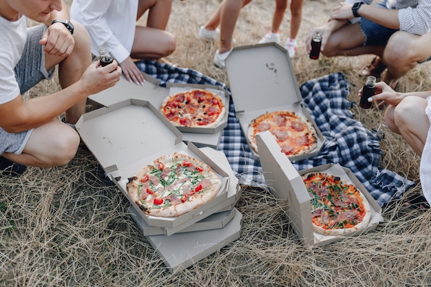 Picnic amigos con pizza y bebidas.