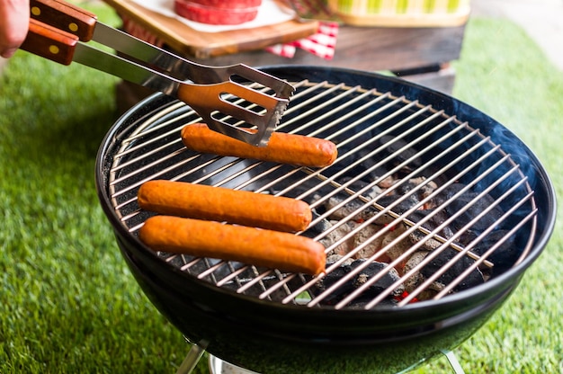 Picnic de verano con una pequeña parrilla de carbón en el parque.