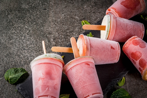 Picolés de sorvete caseiro. bebidas congeladas. cocktail congelado de melancia ou bagas, hortelã e limão.