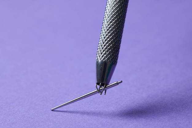 Piercing Ohrringe Nahaufnahme auf violettem Hintergrund