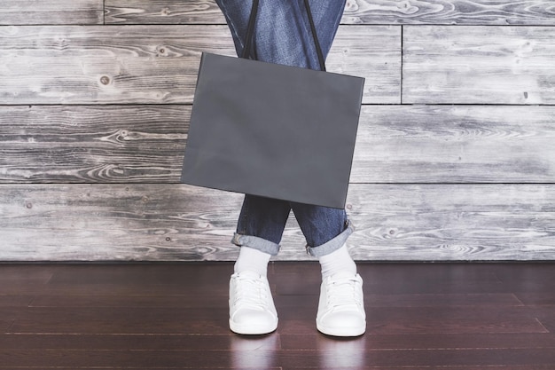 Piernas femeninas con bolsa de compras