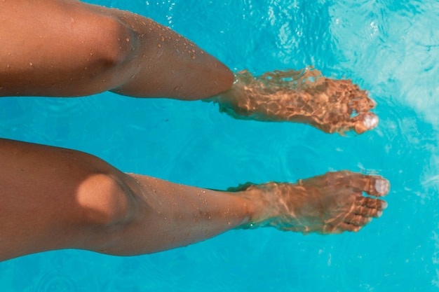 piernas, de, mujer bronceada, en, piscina