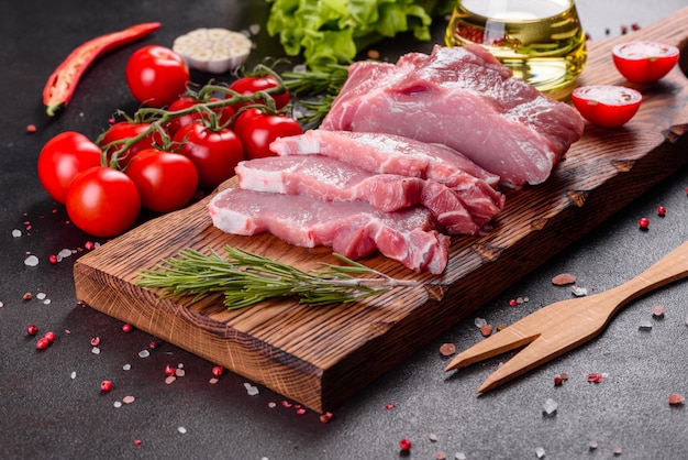 Piezas frescas de cerdo listo para cocinar en la cocina. Medallones de solomillo filetes en una fila listos para cocinar