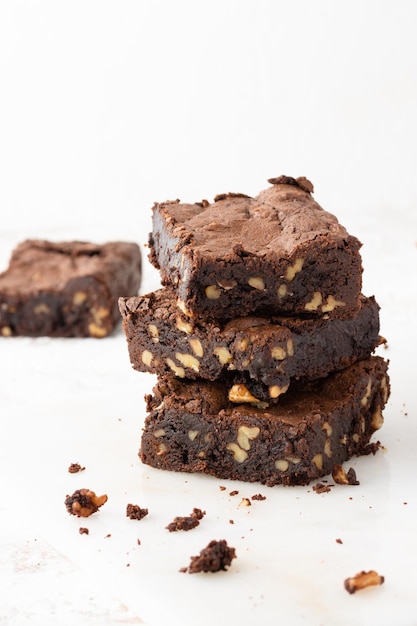 Pila de brownies de chocolate y nueces sobre fondo blanco Primer plano