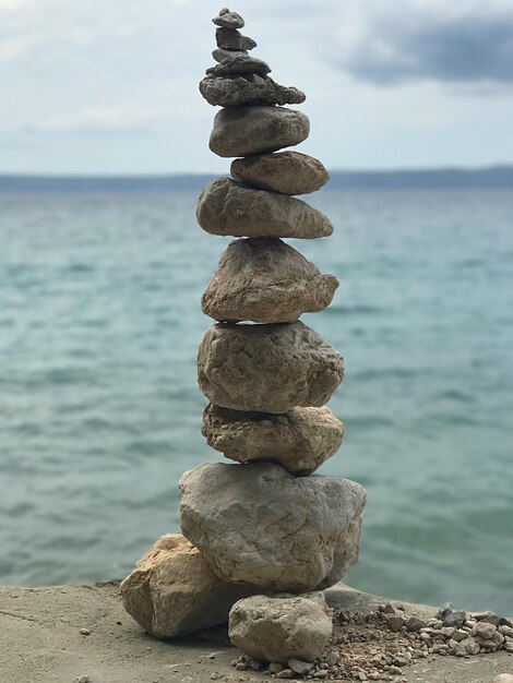 Una pila de guijarros por el mar contra el cielo