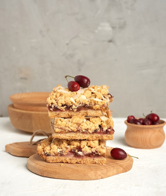 Pila de pastel crumble horneado con relleno de frutas y espolvoreado con almendras ralladas