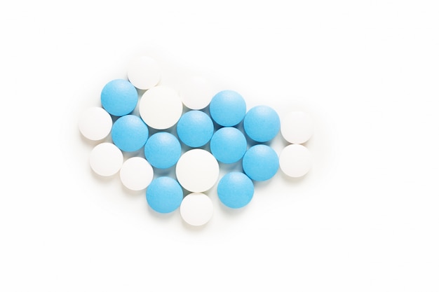 Las píldoras azules y blancas del concepto de la salud y del medicamento o las tabletas en blanco con el espacio de la copia