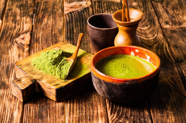 Pilha de chá em pó matcha e bebida matcha em uma tigela