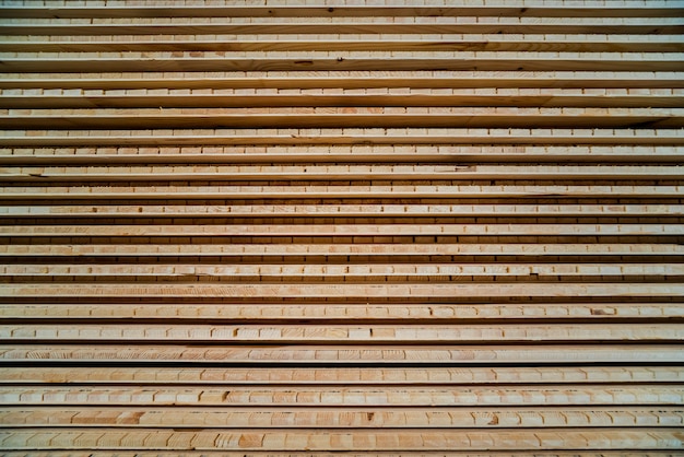 Pilha de tábuas de madeira ásperas naturais.