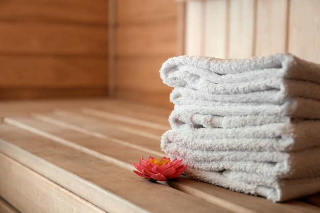 Pilha de toalhas em banco de madeira na sauna