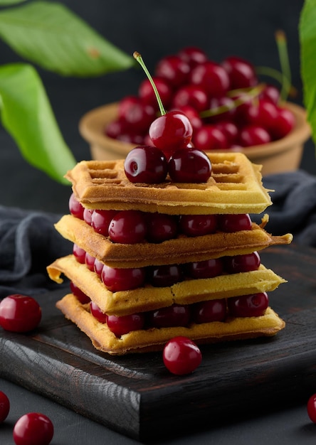 Pilha de waffles belgas assados com cerejas vermelhas maduras breakfastx9