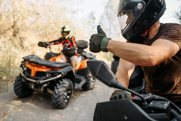 Piloto de ATV mostrando los pulgares para arriba a su compañero