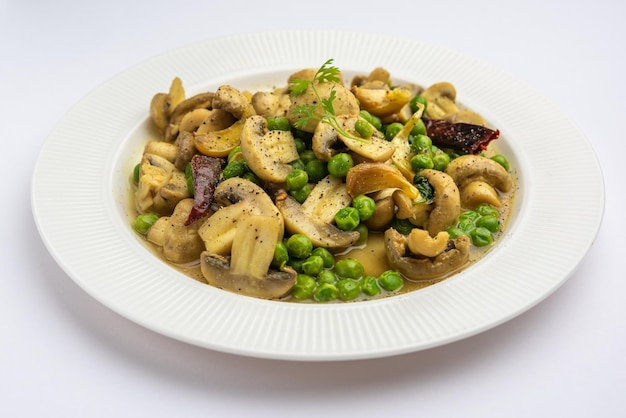 Pilz-Erbsen-Curry mit geröstetem Knoblauch Indisches Essen in einer Schüssel serviert