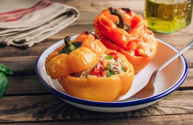 Pimientos de paprika rellenos de campana de colores con arroz de carne y verduras sobre fondo de madera rústica Enfoque selectivo