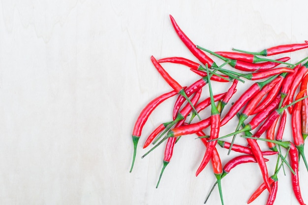 Pimientos picantes rojos frescos con picante en la mesa de madera con espacio de copia