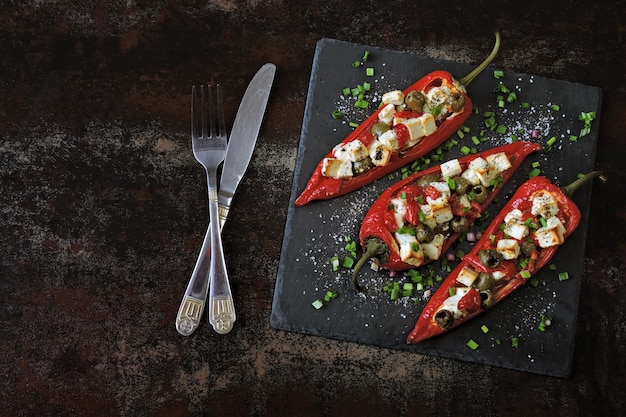 Pimientos rellenos de queso feta y aceitunas. Pimentón al horno con aceitunas y queso blanco. Comida vegetariana. Dieta Keto.